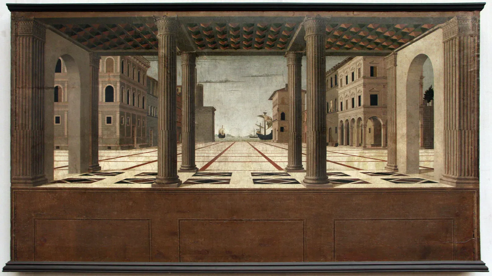 View of the painting Ideal City, showing a linear-perspective square framed by classical architecture.