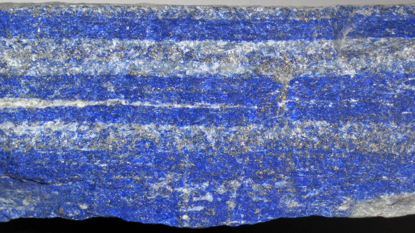 Lapis lazuli specimen from Sar-e Sang, Afghanistan, showing blue lazurite, white calcite and golden pyrite
